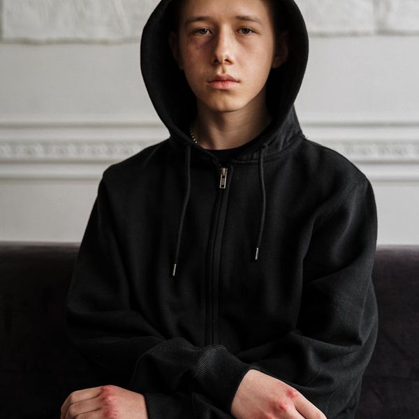 Person sitting peacefully with a calm expression.